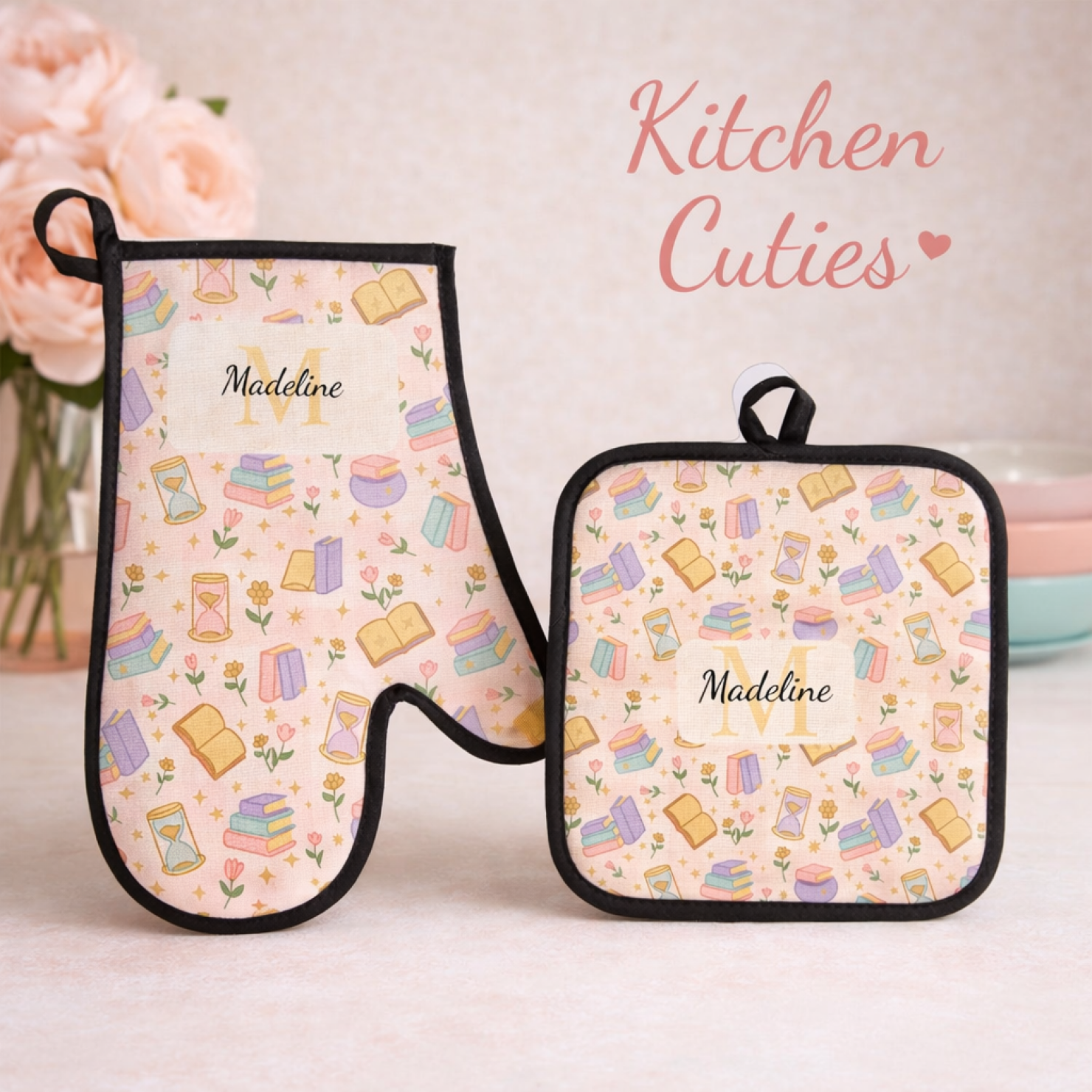 Personalized kitchen accessories featuring an oven mitt and pot holder with a colorful book and flower pattern, labeled 'Madeline' and 'Kitchen Cuties' text.
